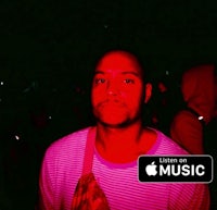 a man in a red shirt standing in front of a crowd